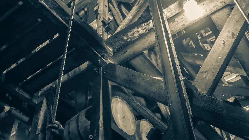 A complex industrial structure with metal beams and pipes.