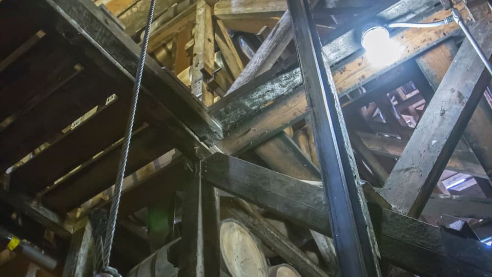A complex metal structure with beams and cables, likely part of an industrial or construction site.
