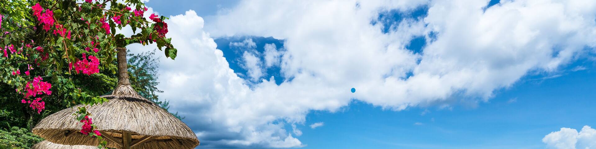Public beach with lounge chairs and umbrellas in Pointe aux Canonniers, Mauritius island, Africa