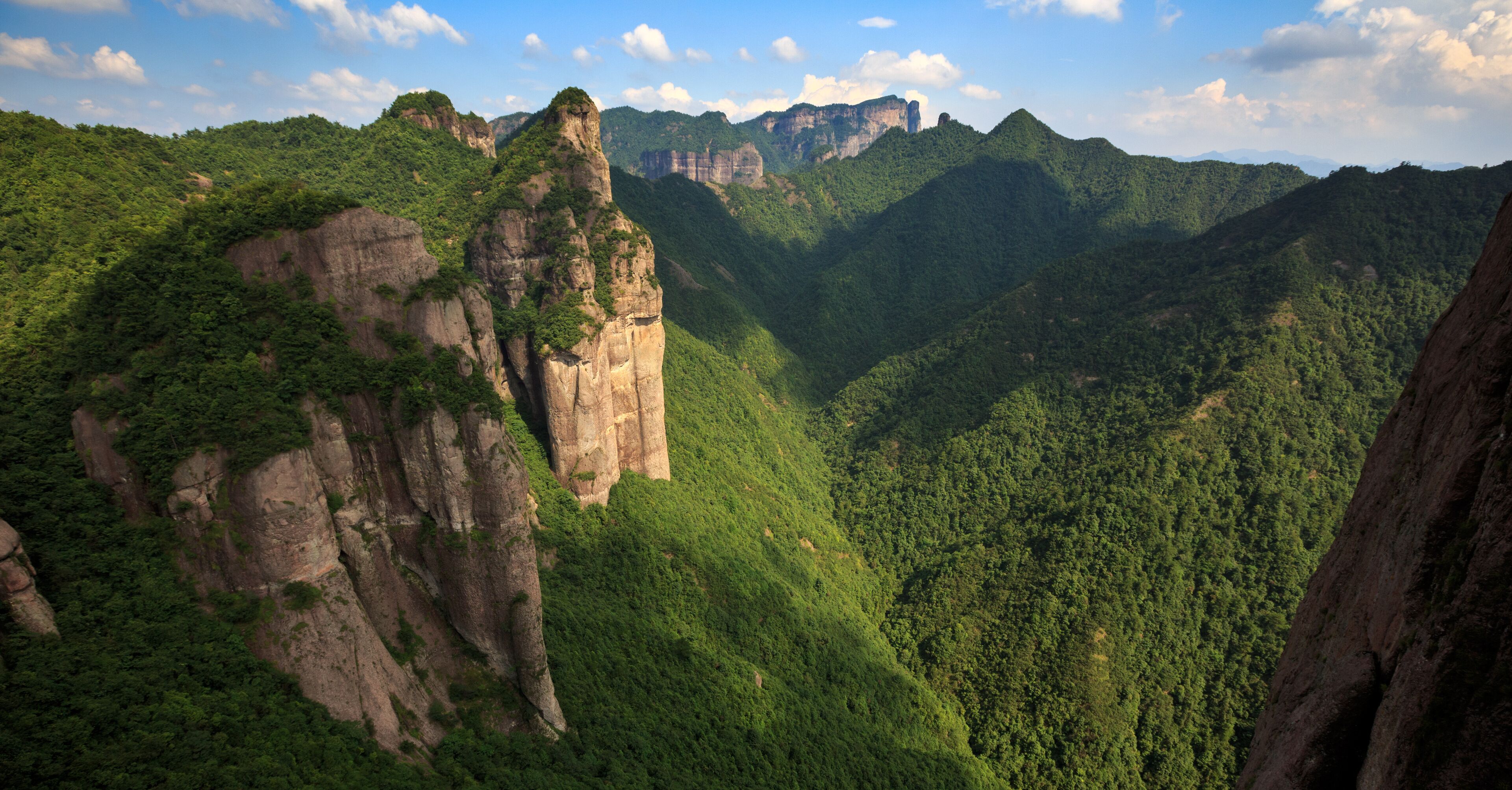 Shenxianju Scenic Area - Xianju County, Taizhou, Zhejiang Province China. Known as the "Place Where Spirits Reside", Chinese Canyon Scenery with steep cliffs,  aerial view above green forests below