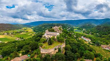 Menerbes village in Provence on a summer day, France, Luberon, Vaucluse. Village of Menerbes, the village and the Luberon mountains also called the most beautiful village of Luberon, France, Provence.