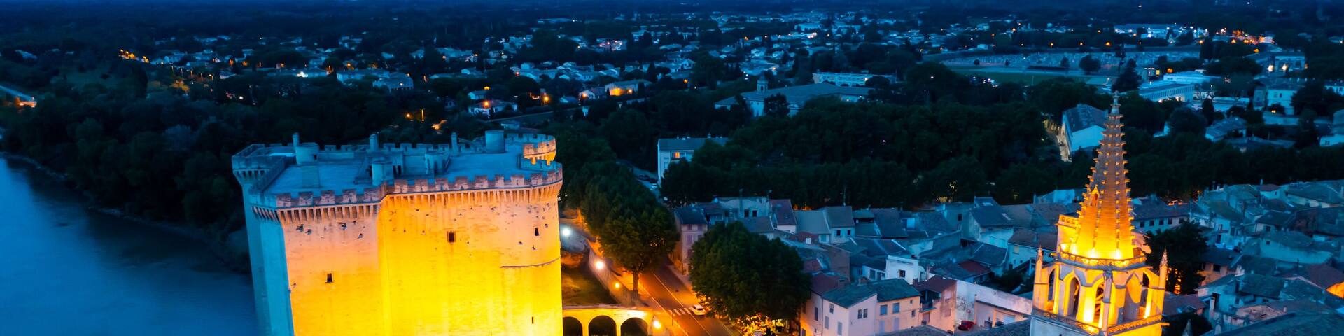 Aerial photo of Tarascon Castle along the Rhone River in evening, Tarascon, France.