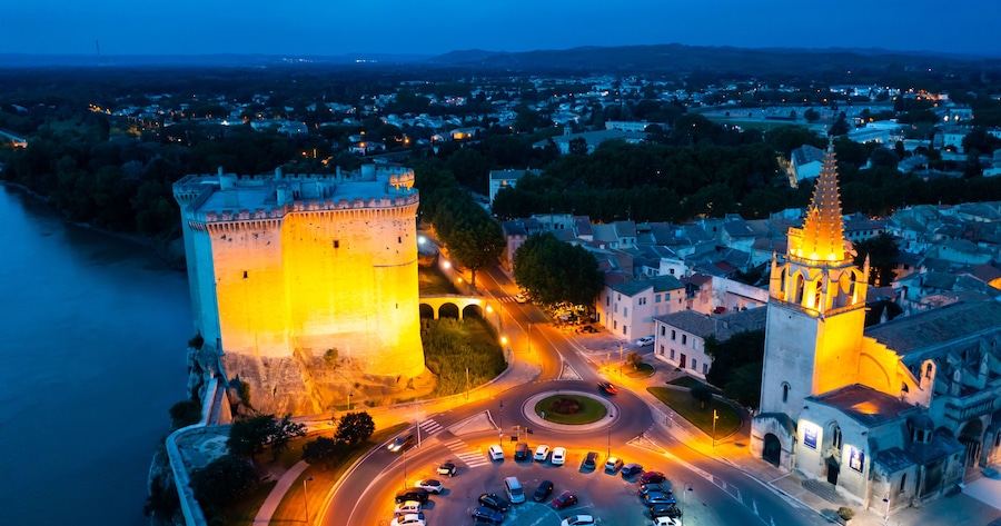 Aerial photo of Tarascon Castle along the Rhone River in evening, Tarascon, France.