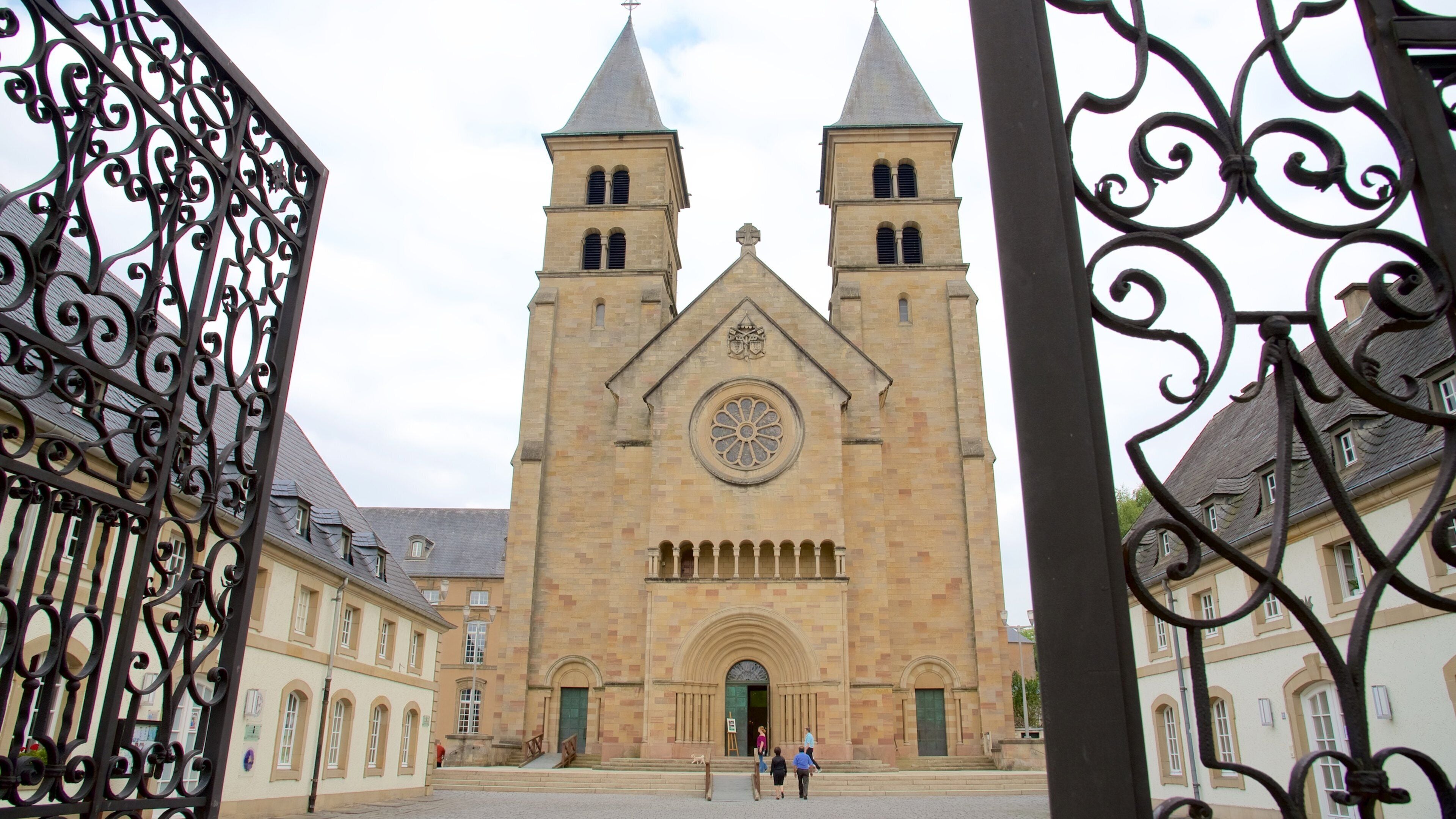 A historic church with two towers and a large circular window.
