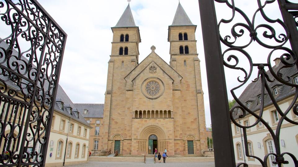 A historic church with two towers and a large circular window.