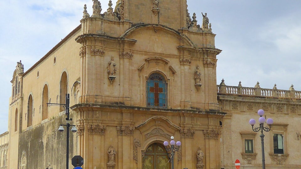 A historic church with ornate architecture, a prominent entrance, and a bell tower.