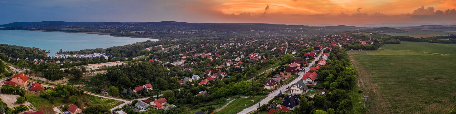 Balatonfuzfo, Hungary - Aerial panoramic skyline view of the small town of Balatonfuzfo by the Lake Balaton at sunset on a colorful summer afternoon