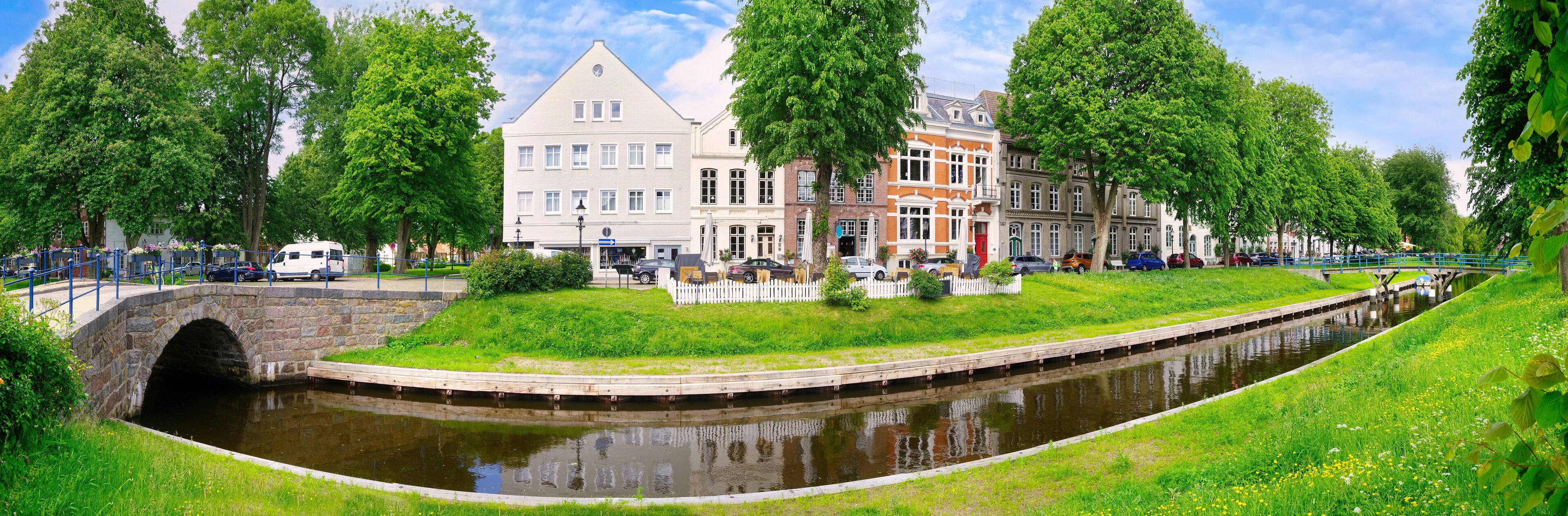 Historic houses and bridge on a sunny day in summer in Friedrichstadt, Germany