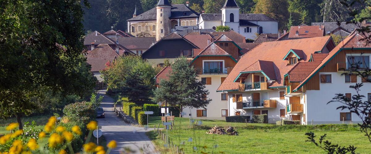 A village with traditional houses, a church, and a tower.