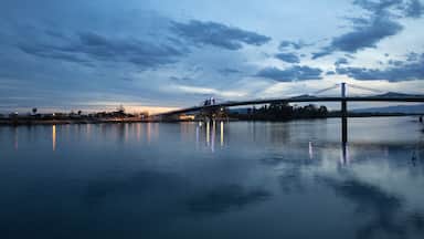 A bridge over calm water with a twilight sky.
