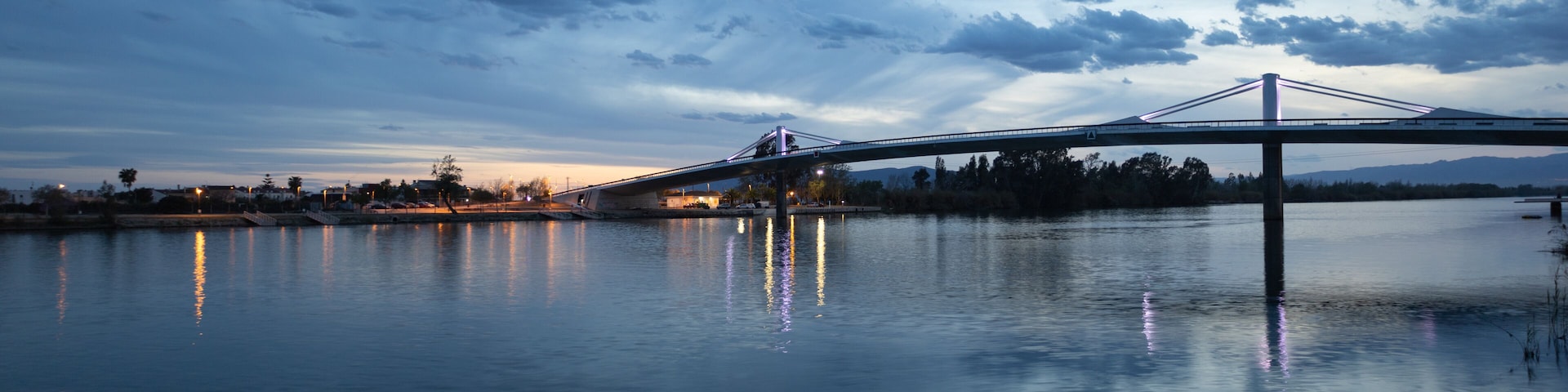 A bridge over calm water with a twilight sky.