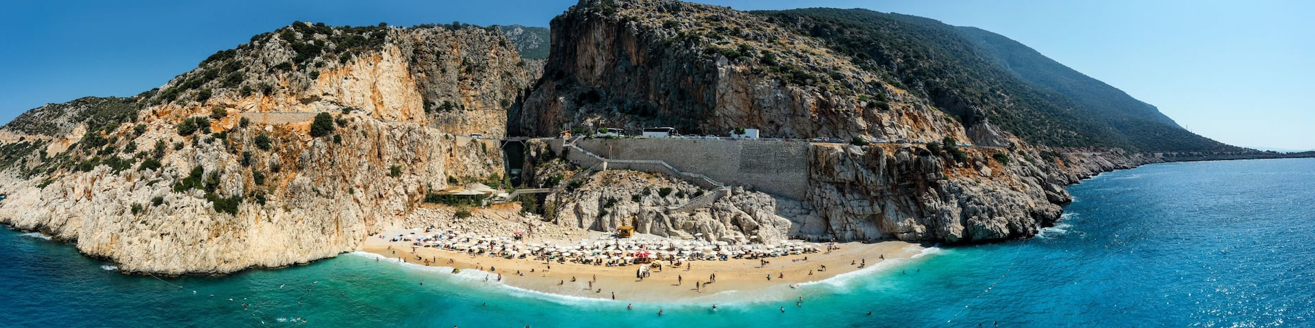 Kaputas beach. People enjoying sun and sea at the beautiful turquoise sea and sandy beach of Kaputas. Bird's eye view aerial drone shooting. Mediterranean, Kas / Antalya – TURKEY