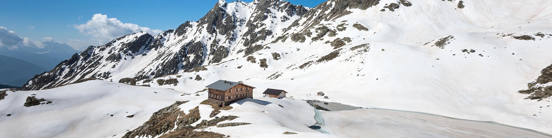Terento, South Tyrol, Italy. The refuge Lago di Pausa / Tiefrastenhuette and the frozen lake