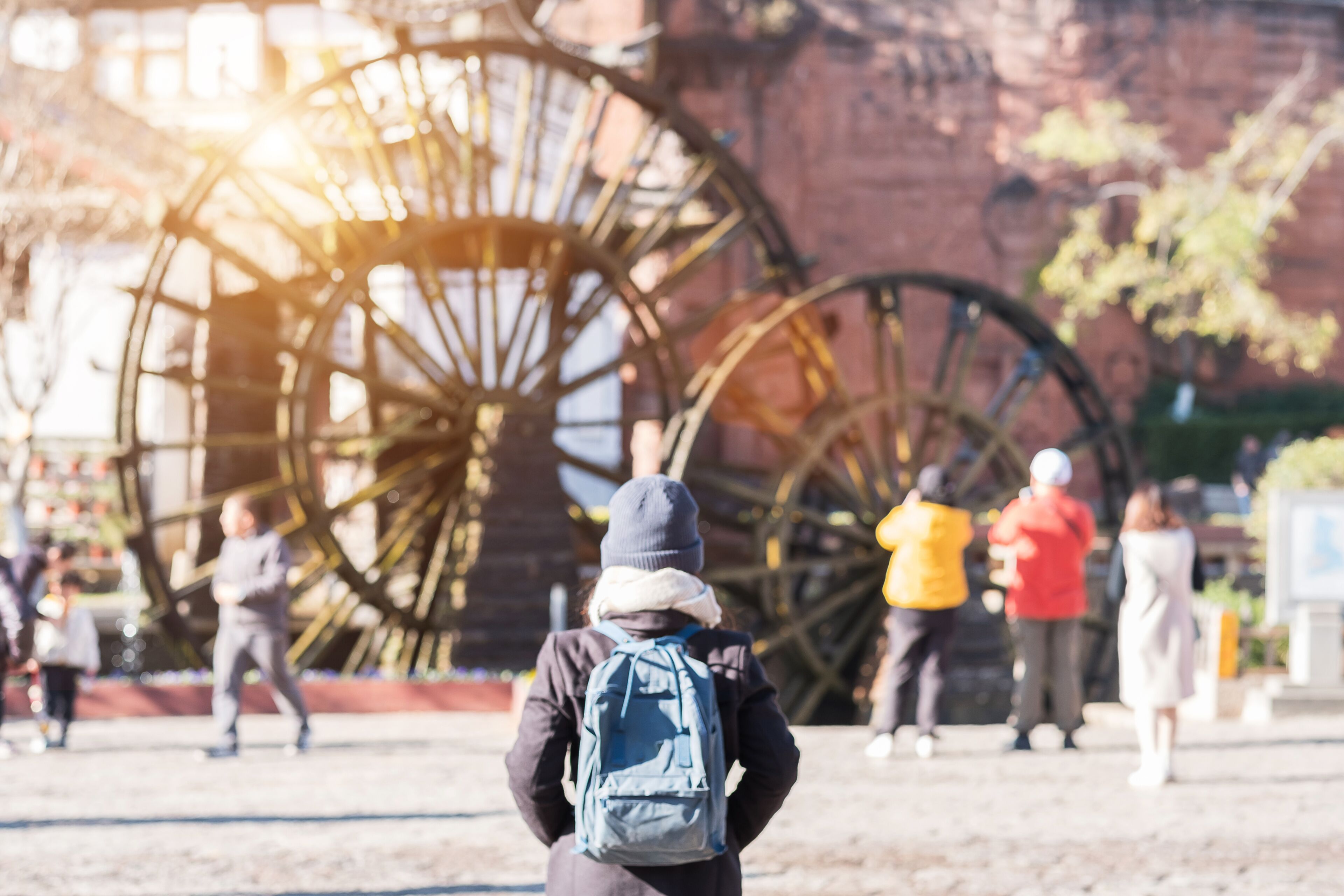 young woman traveler traveling at Giant Water Wheels in Lijiang Old Town, landmark and popular spot for tourists attractions in Lijiang, Yunnan, China. Asia travel concept