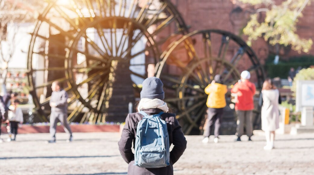 young woman traveler traveling at Giant Water Wheels in Lijiang Old Town, landmark and popular spot for tourists attractions in Lijiang, Yunnan, China. Asia travel concept