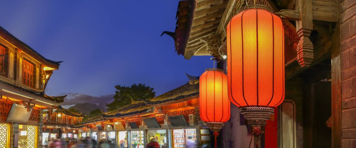 A traditional Chinese courtyard with ornate lanterns and tiled roofs.