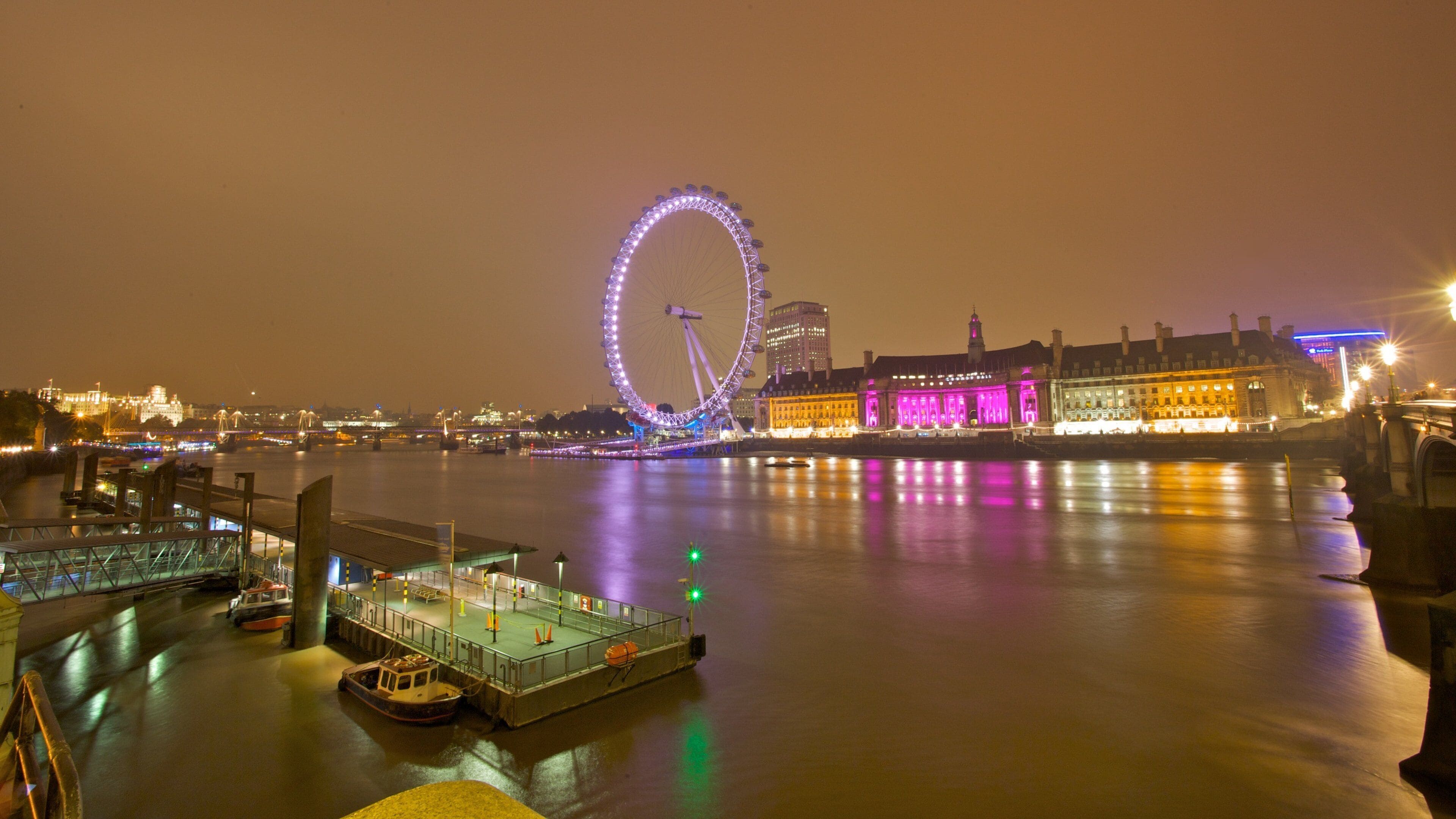London Eye which includes a river or creek, a city and night scenes