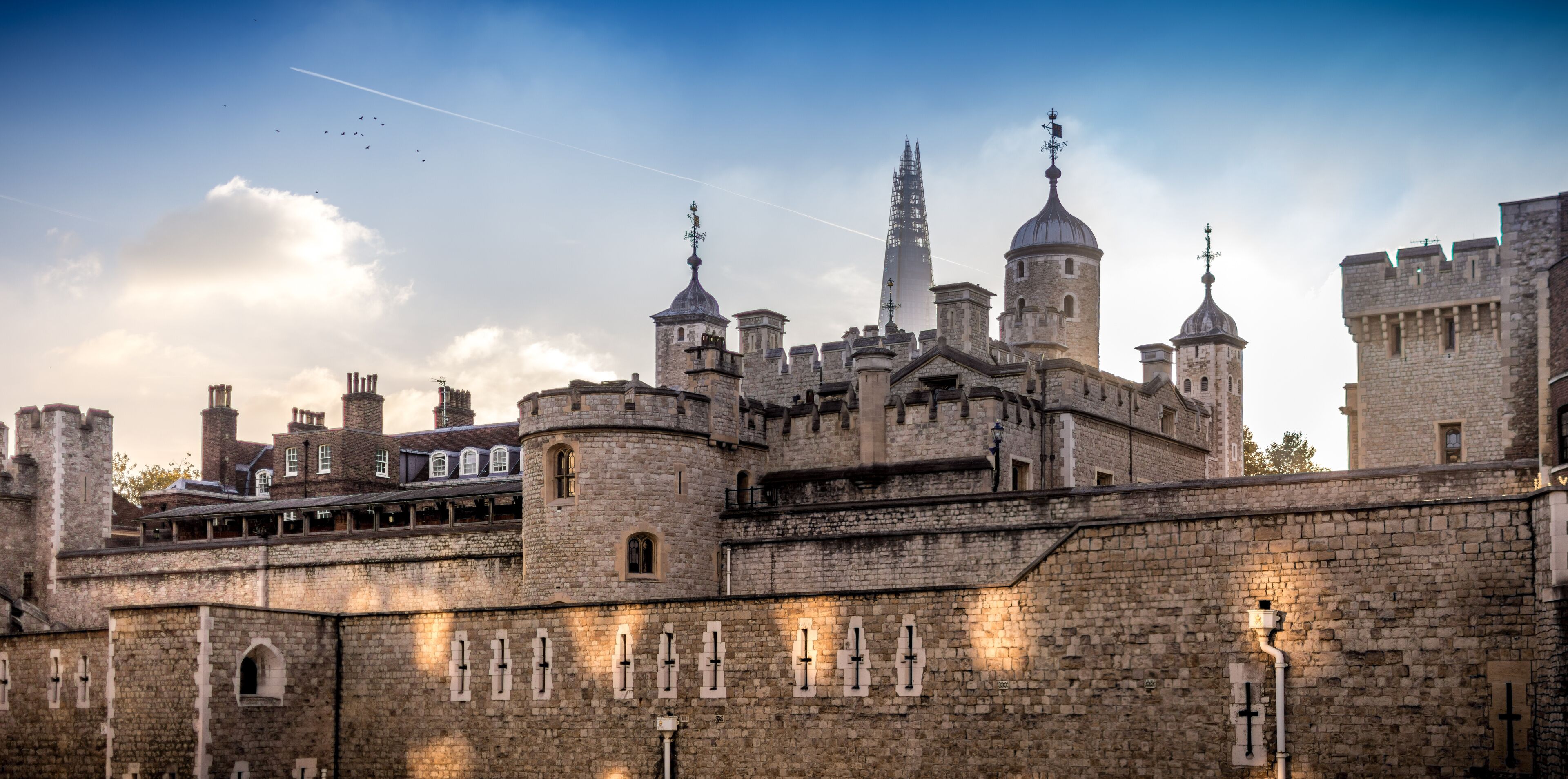 A historic castle with multiple towers and a prominent spire.