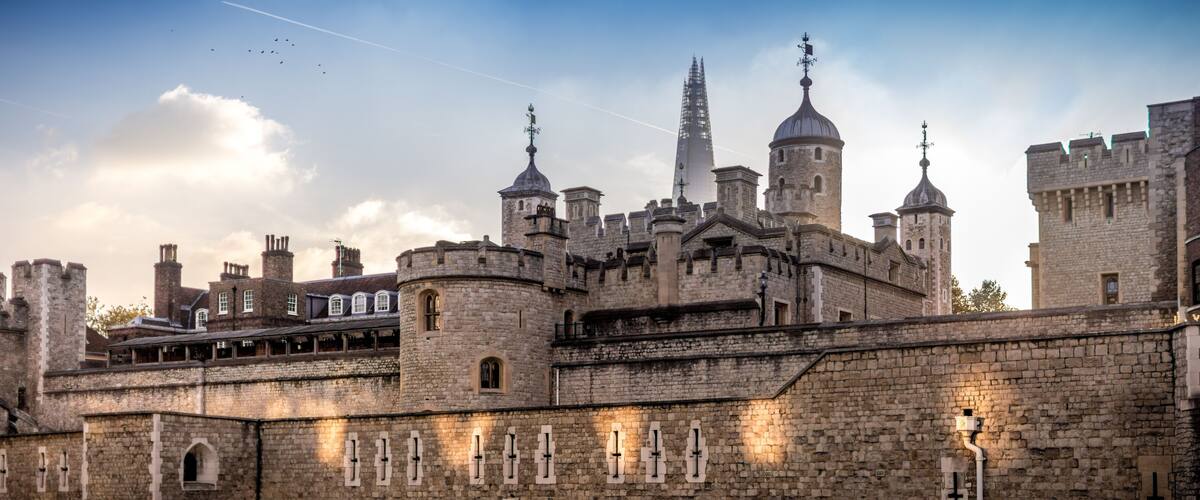 A historic castle with multiple towers and a prominent spire.