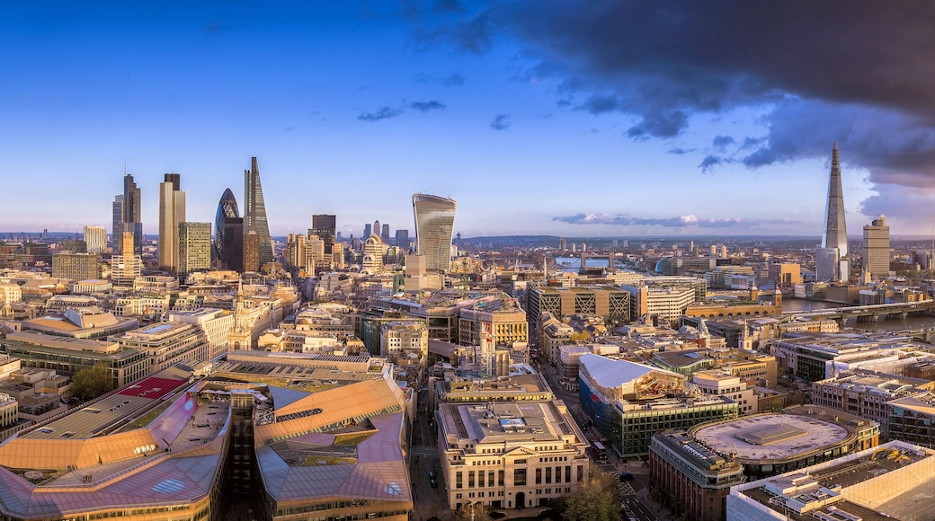London, England - Panoramic skyline of the famous bank district of London, the leading financial district of the world at sunset with skyscrapers and dark clouds