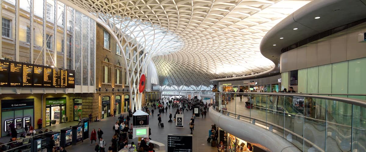 Kings Cross St. Pancras which includes modern architecture and interior views as well as a large group of people