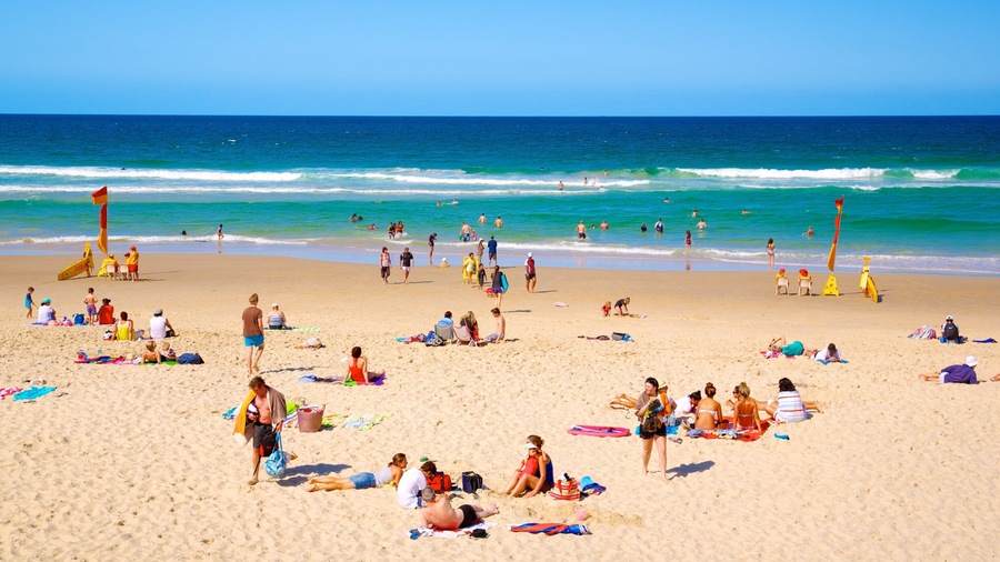 Southport which includes a sandy beach, swimming and tropical scenes