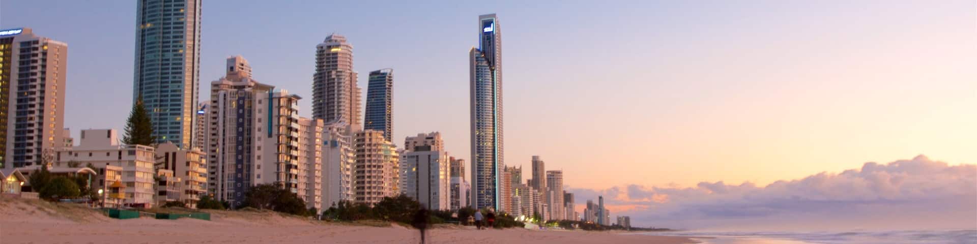 A beach with high-rise buildings in the background.