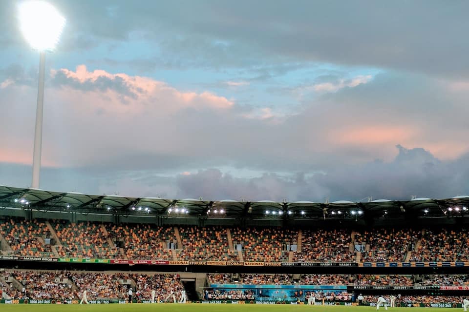 A stadium filled with spectators under a cloudy sky.