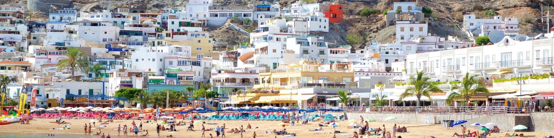 Playa de Mogan featuring general coastal views, a sandy beach and a coastal town