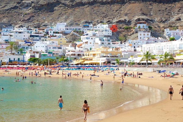 Playa de Mogan featuring general coastal views, a sandy beach and a coastal town