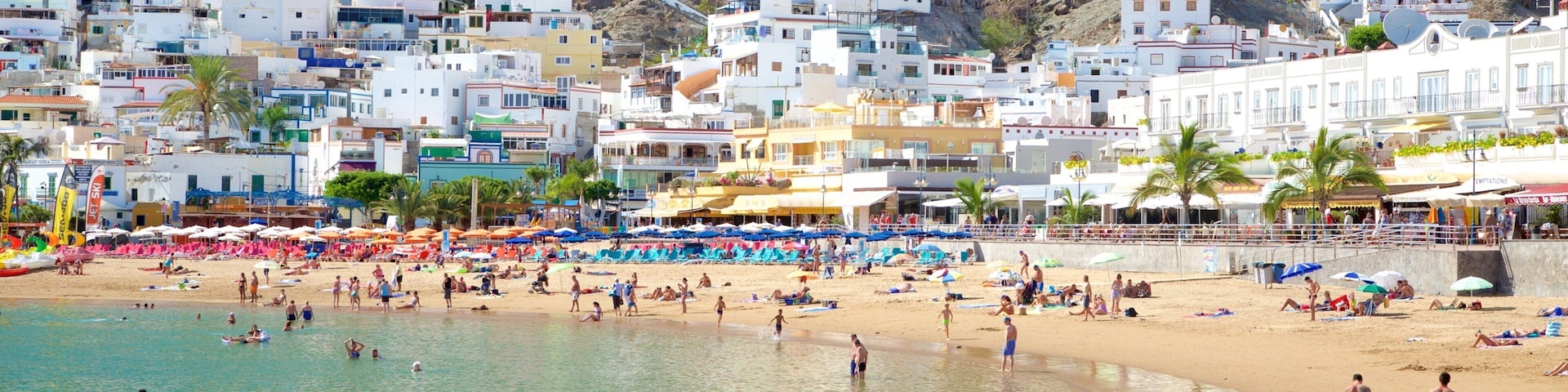 Playa de Mogan featuring general coastal views, a sandy beach and a coastal town