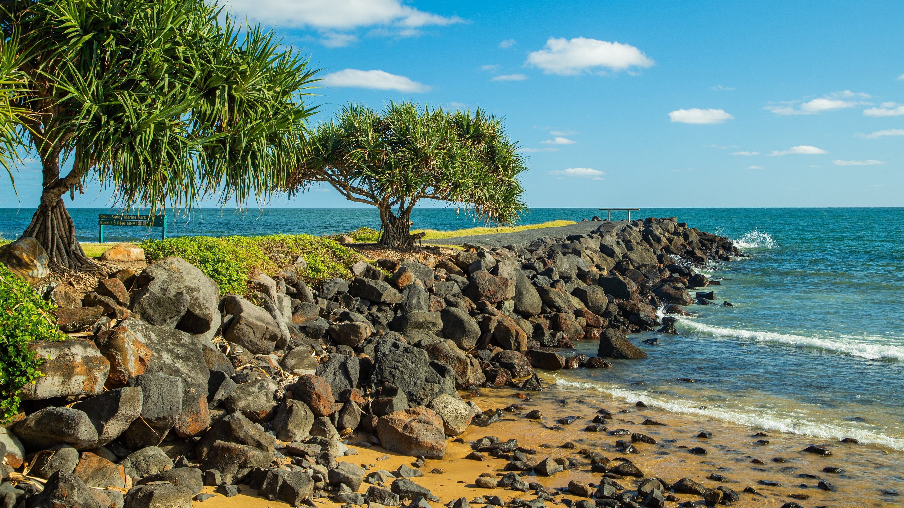 Bargara which includes general coastal views and a pebble beach