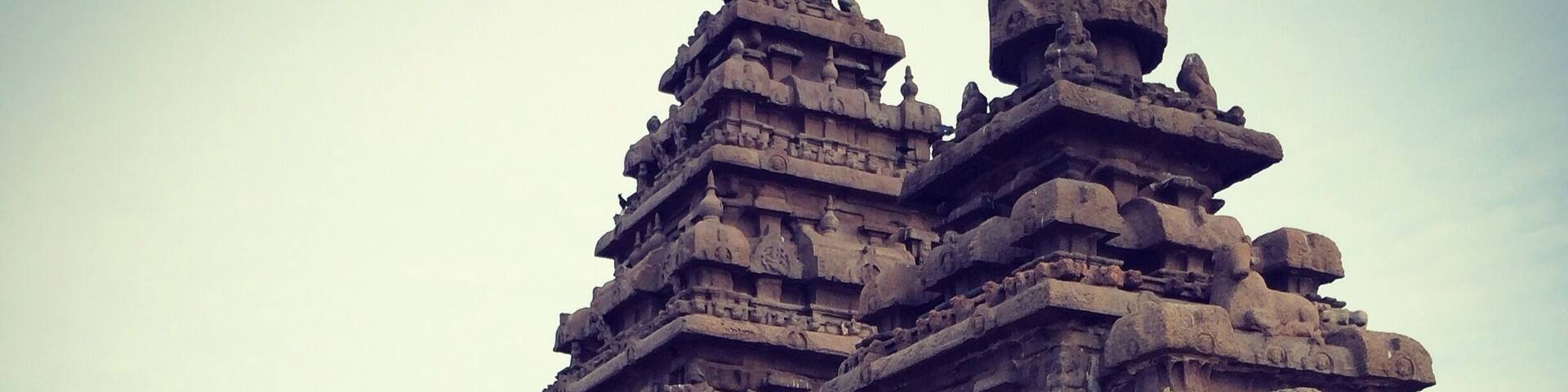A temple with intricate carvings and large stone lion statues.