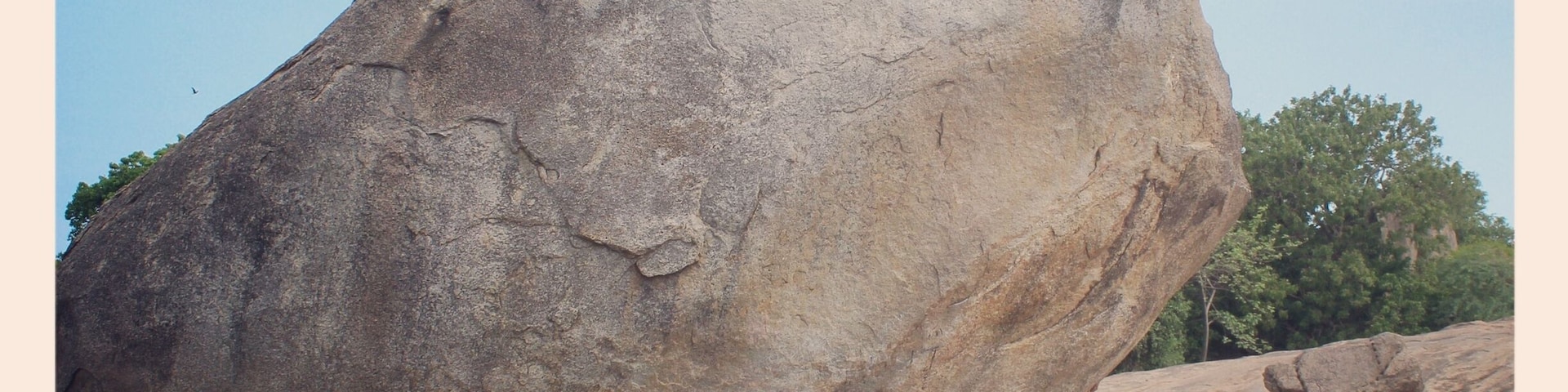This is a photo of me trying to push 'The Krishna's butterball.' The stone is called Krishna's butterball because even when its shape is a circular one still it manages to balance on a inclined plane and even after enormous efforts the stone was not be able to rolled down the surface.