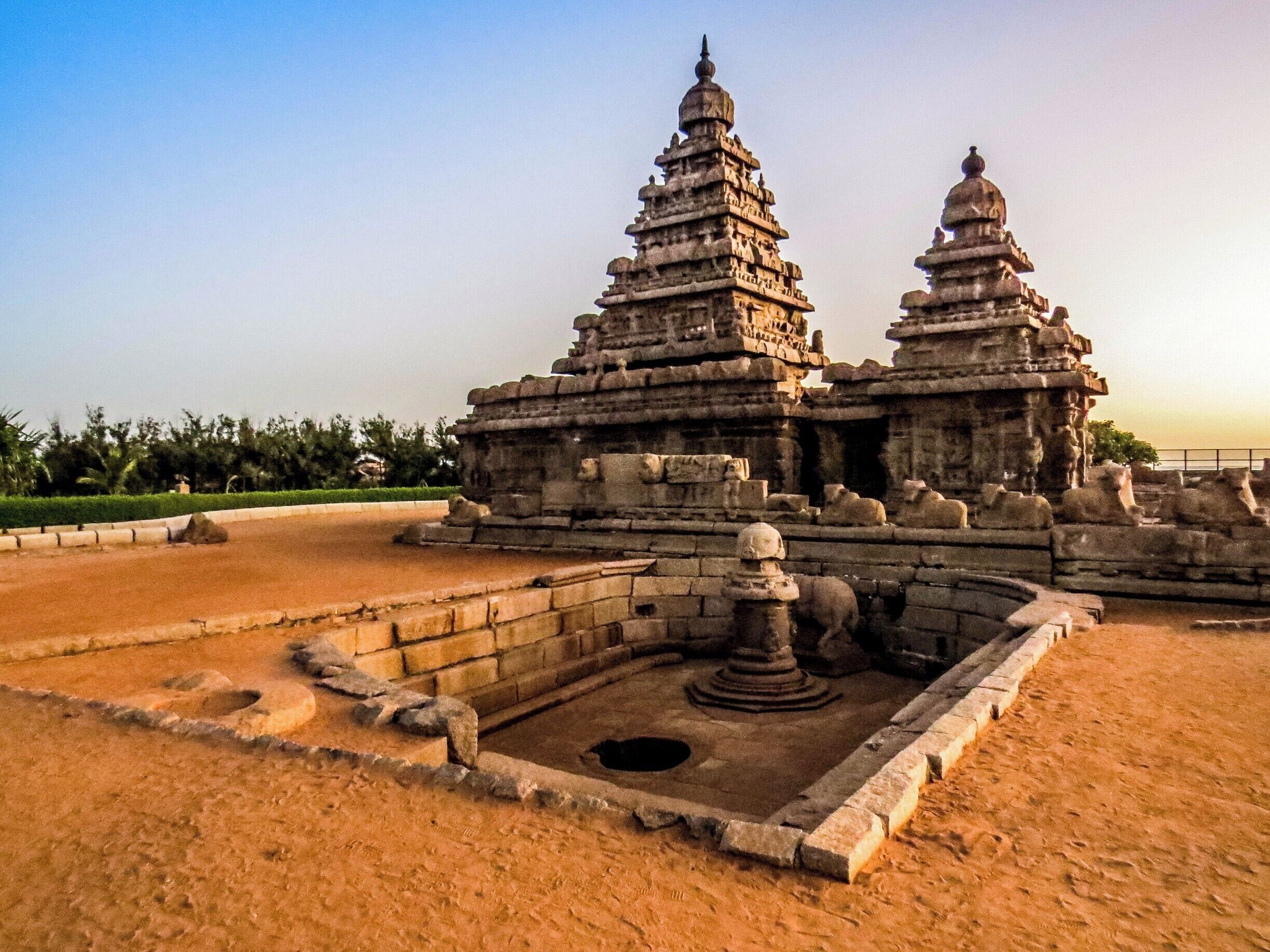 The Shore Temple at Mahabalipuram, India. It was built with blocks of granite, dating from the 8th century AD. At the time of its creation, the village was a busy port during the reign of Narasimhavarman II of the Pallava dynasty. As one of the Group of Monuments at Mahabalipuram, it has been classified as a UNESCO World Heritage Site since 1984 and it is one of the oldest structural stone temples of South India.