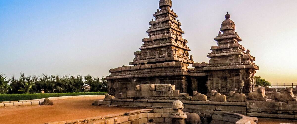 The Shore Temple at Mahabalipuram, India. It was built with blocks of granite, dating from the 8th century AD. At the time of its creation, the village was a busy port during the reign of Narasimhavarman II of the Pallava dynasty. As one of the Group of Monuments at Mahabalipuram, it has been classified as a UNESCO World Heritage Site since 1984 and it is one of the oldest structural stone temples of South India.