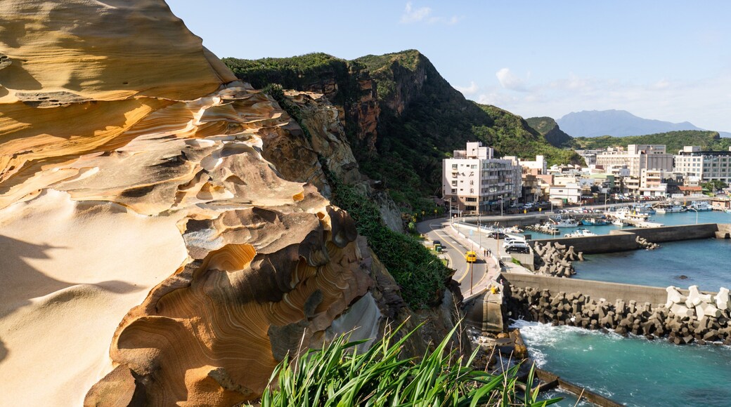Wanli featuring rocky coastline, a coastal town and a bay or harbor