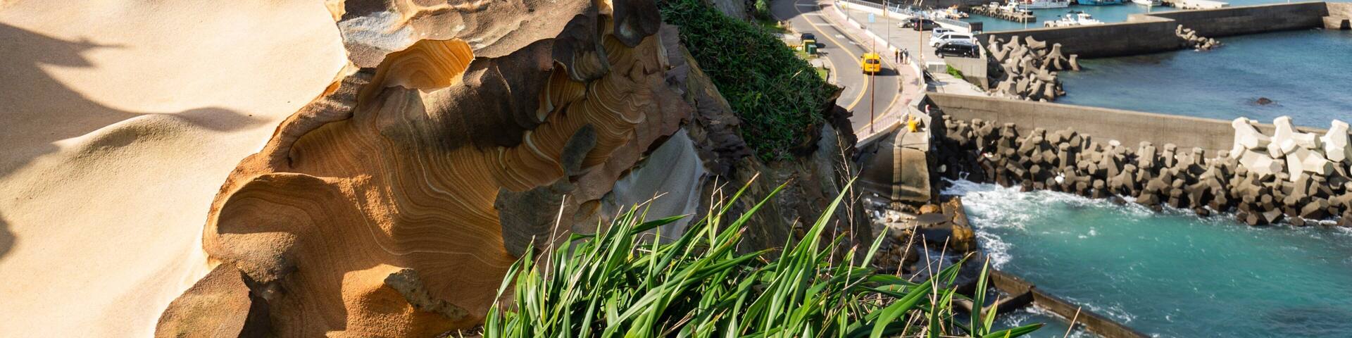 Wanli featuring rocky coastline, a coastal town and a bay or harbor