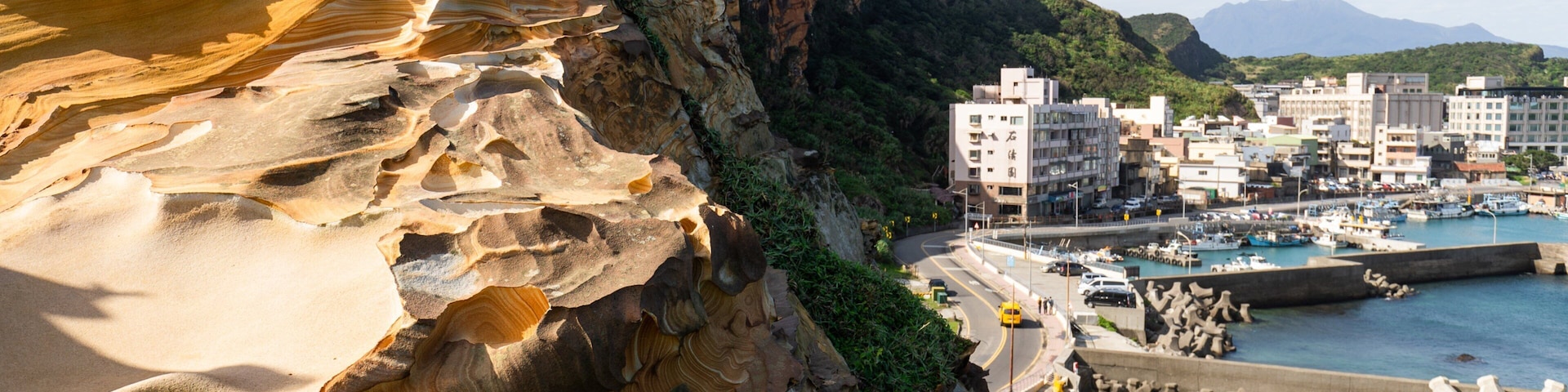 Wanli featuring rocky coastline, a coastal town and a bay or harbor