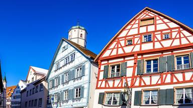 A row of traditional half-timbered houses with a clear blue sky.