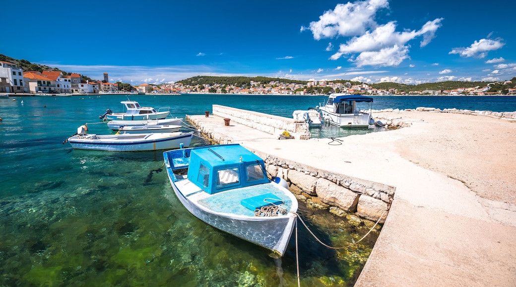 Turquoise coastline and boats in town of Tisno