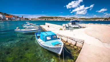 Turquoise coastline and boats in town of Tisno