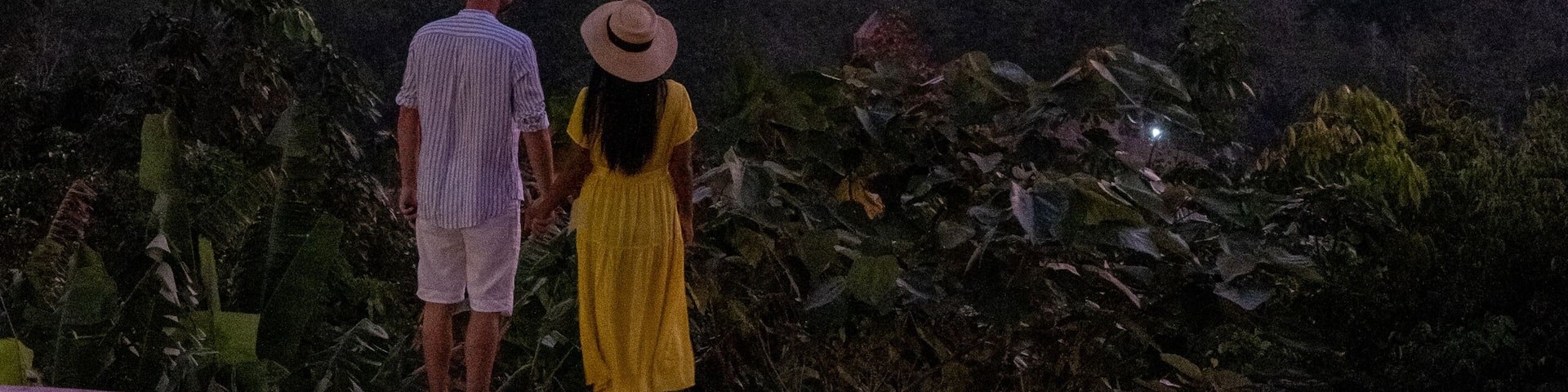 couple watching sunrise over the bay of Phangnga Thailand, men and woman at Samet Nang She viewpoint during sunrise Thailand