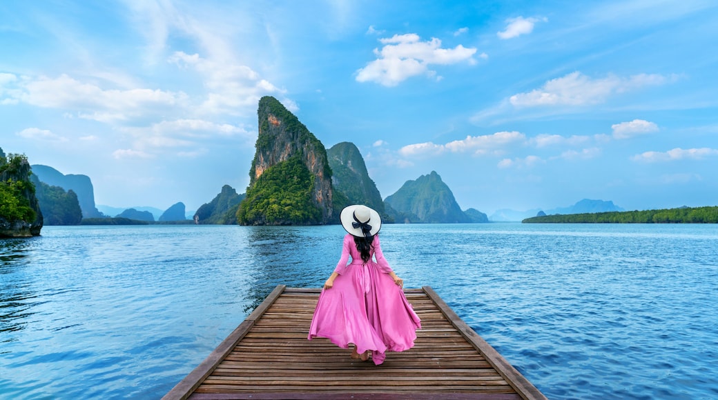 Tourist walking on wooden bridge in Phang nga bay, Thailand.