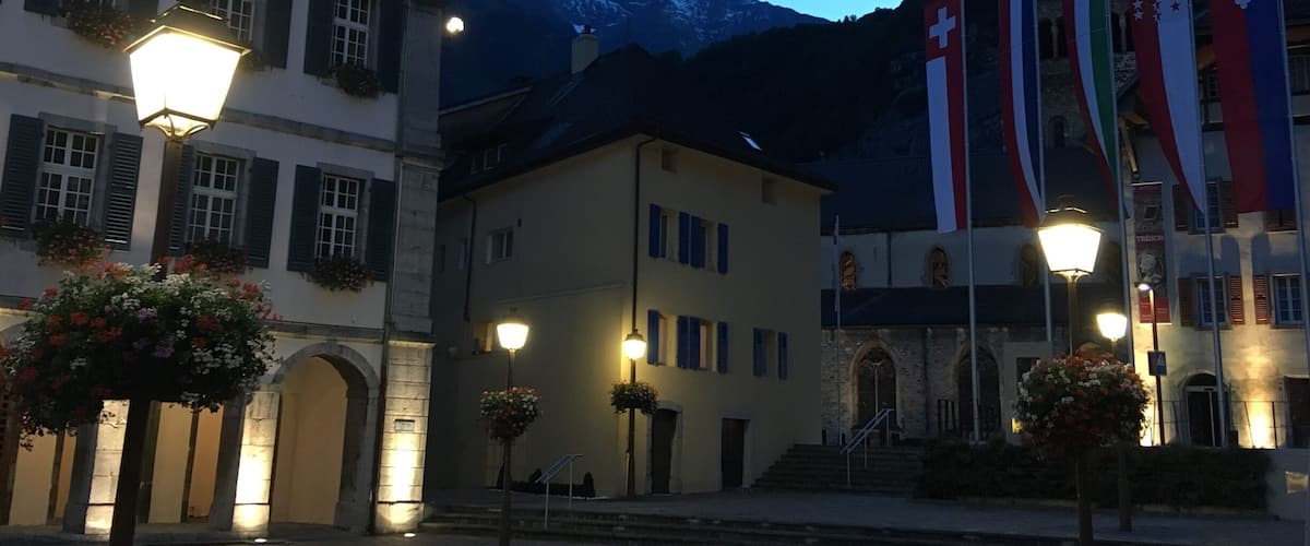 The old town of Saint Maurice with its monastery under the mountains.