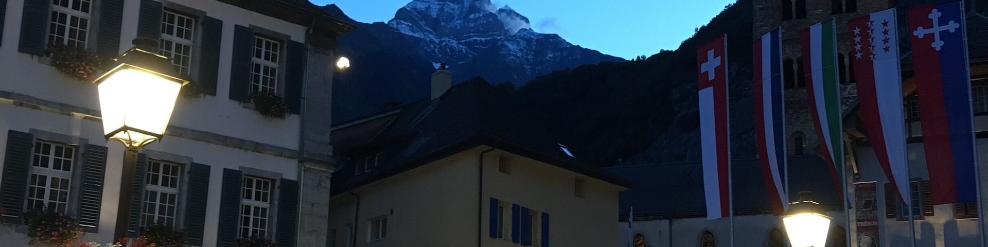 The old town of Saint Maurice with its monastery under the mountains.