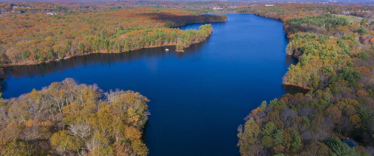 A river winding through a forest with autumn foliage.