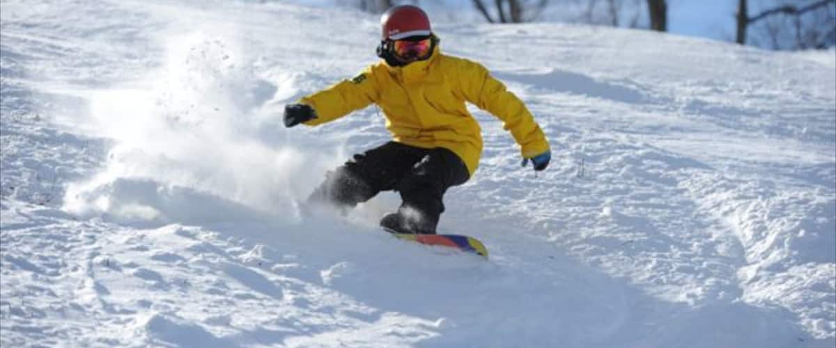 A person snowboarding down a snowy slope.