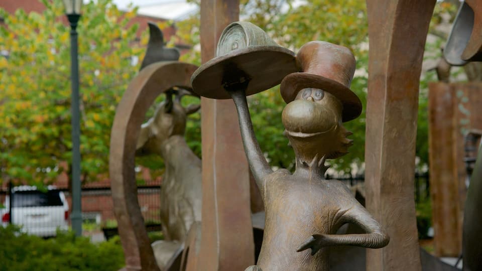 A sculpture of a figure holding a hat.