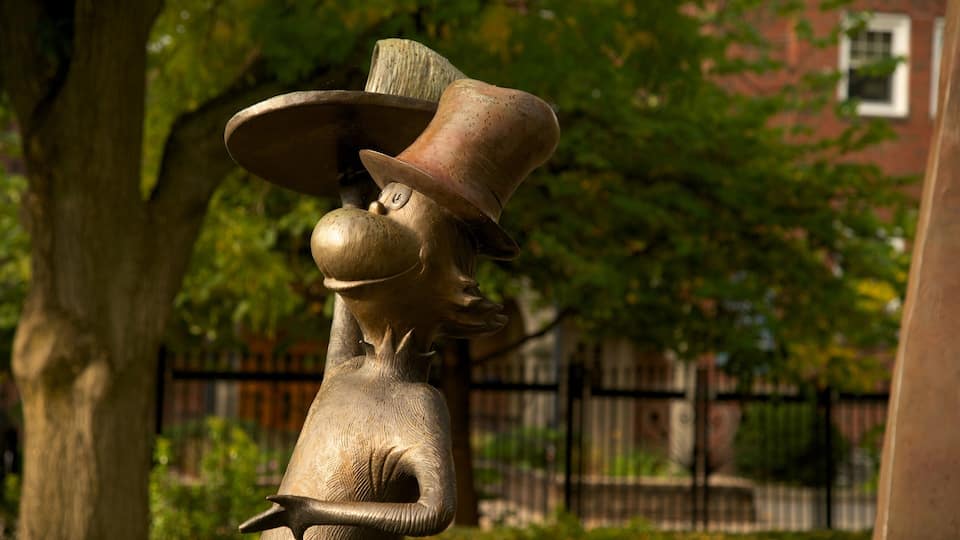 A bronze statue of a man with a top hat and monocle.